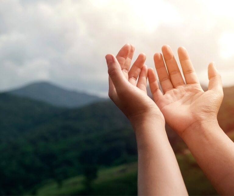 cupped hands lifted towards the sky.